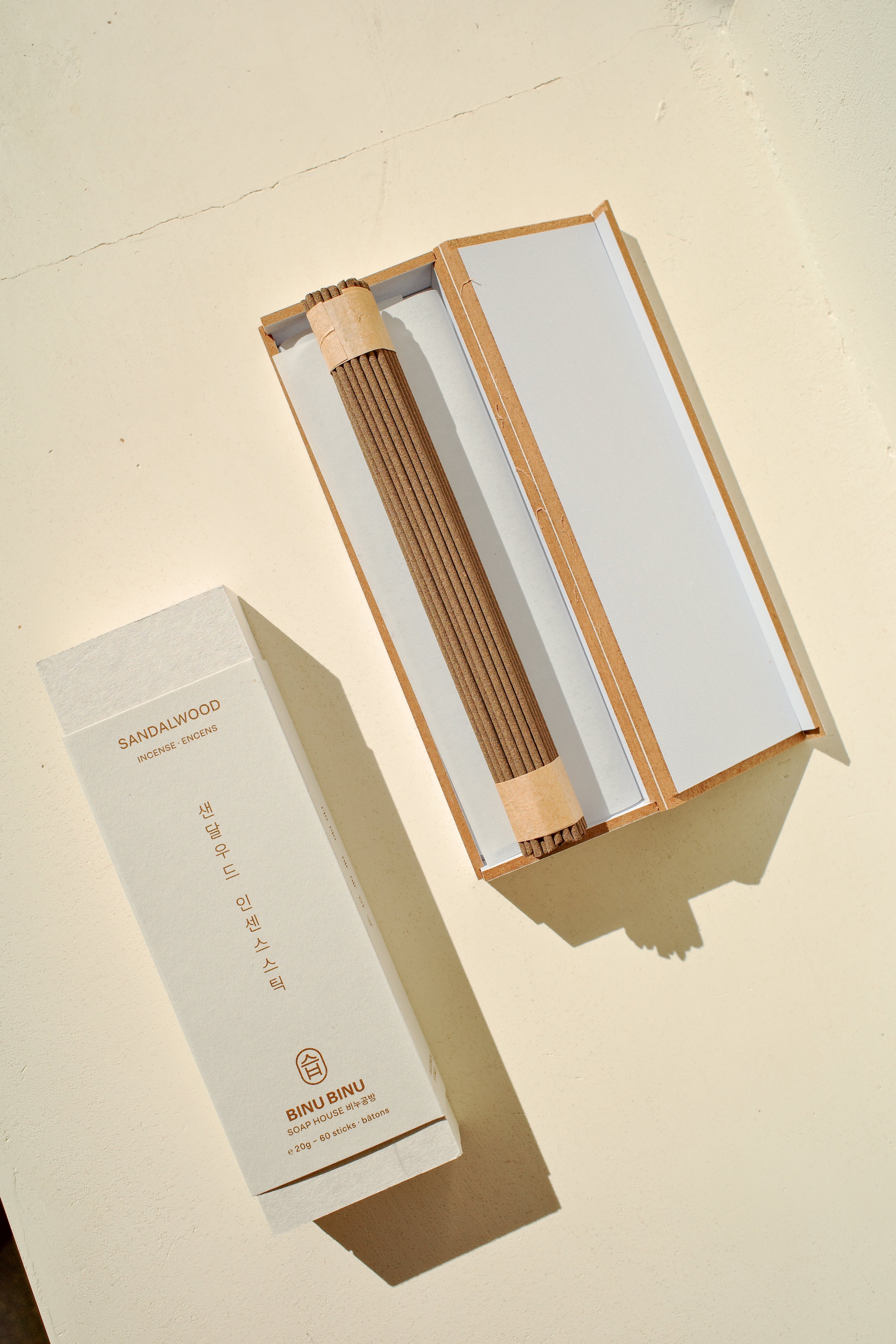 Open box of incense next to packaging.