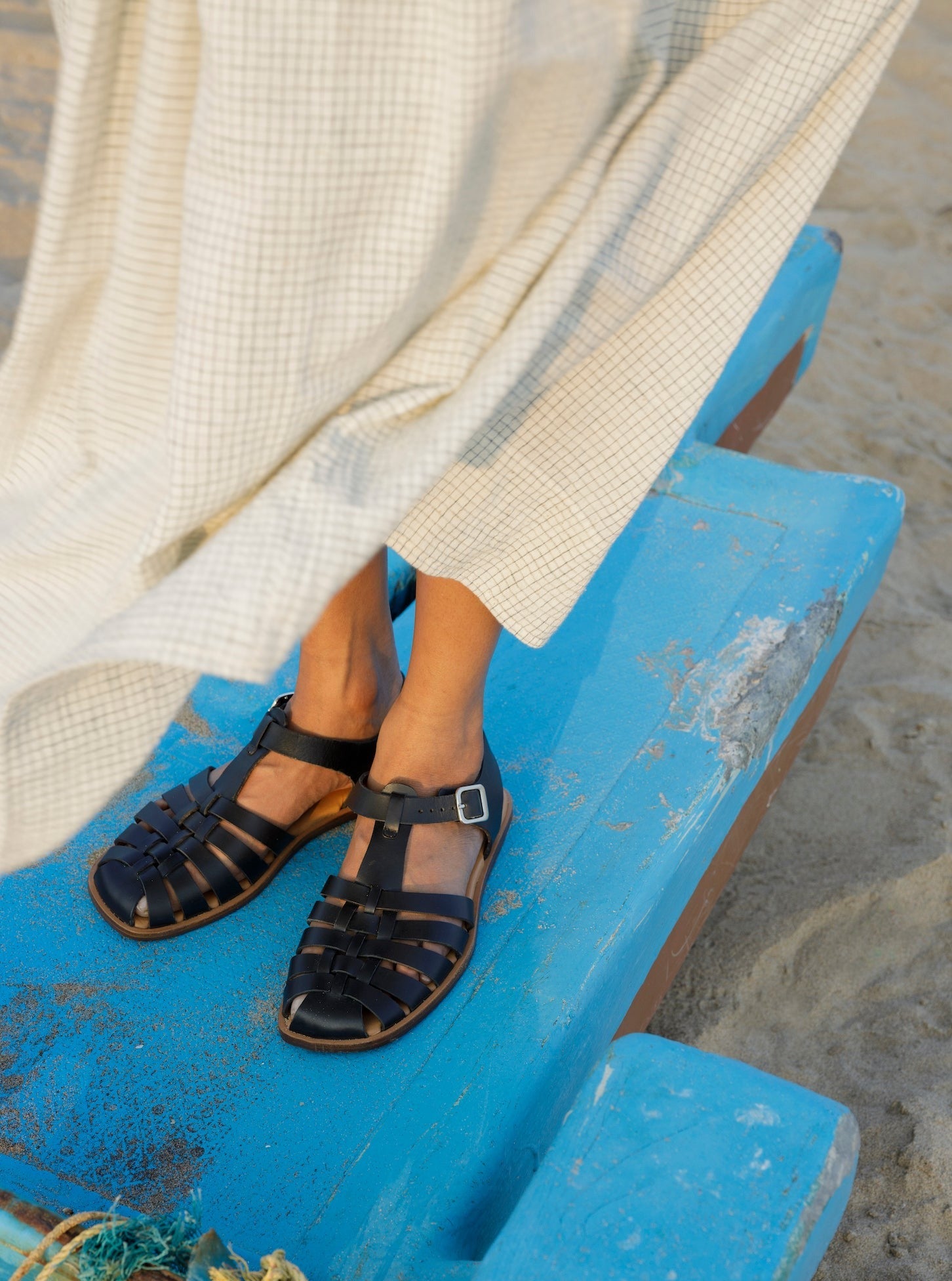 Fisherman sandal with a buckled closure and t-bar vamp in black leather. Vegetable-tanned leather upper and outsole.