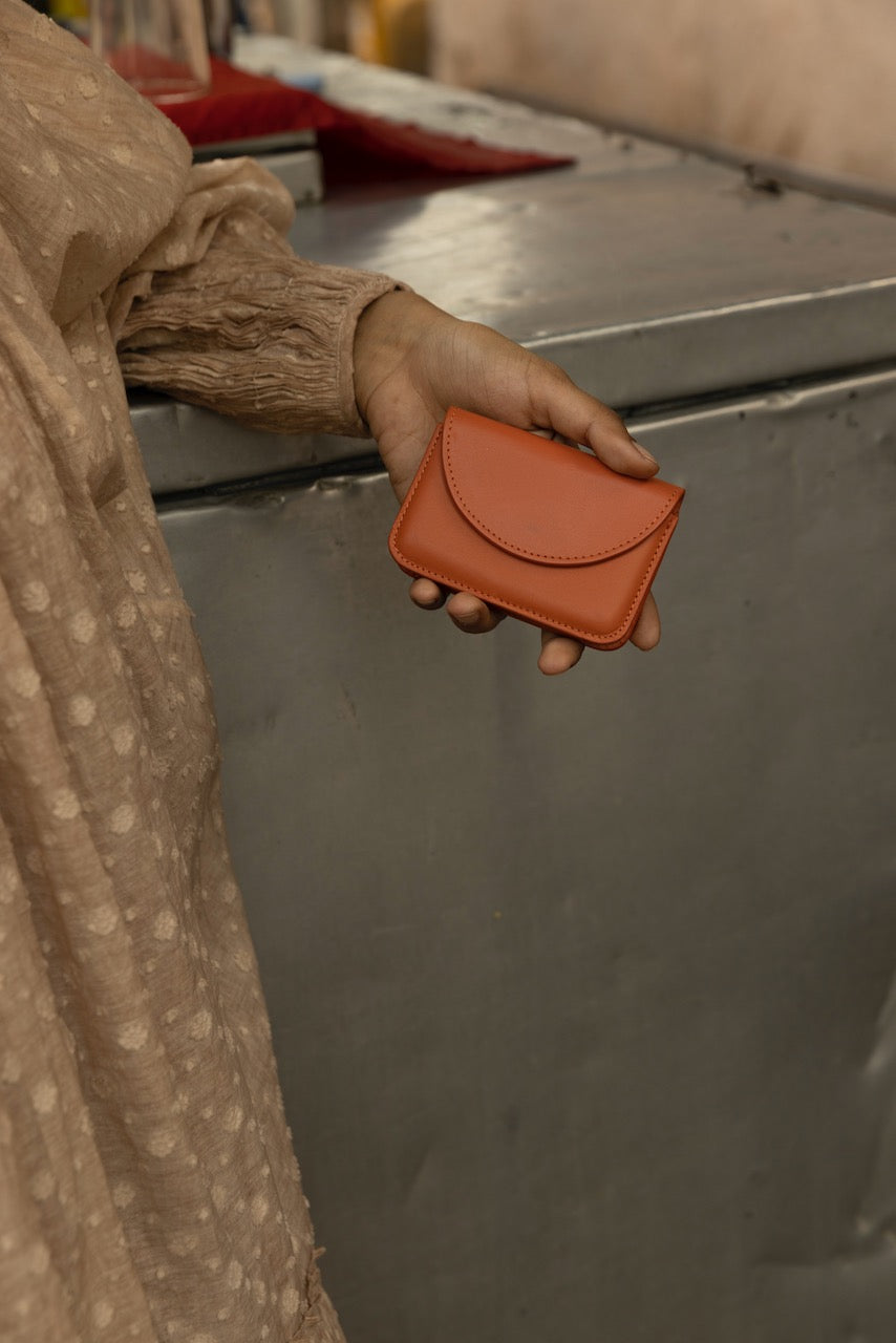 Orange-red, card-sized wallet with envelope-style semicircle flap.