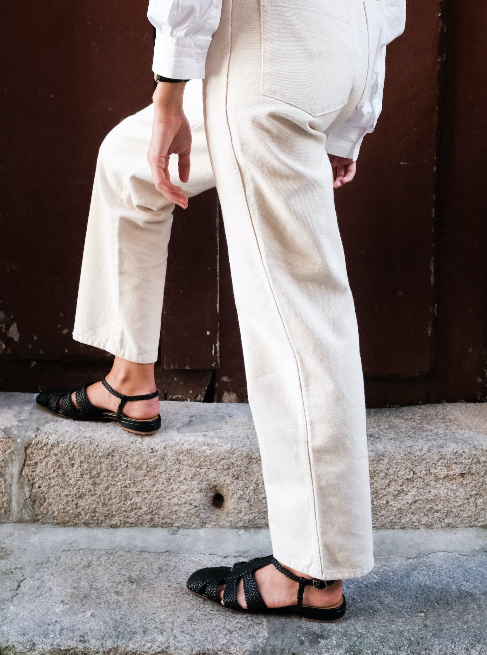 Fisherman-style sandals featuring straps made of woven leather across the foot and a strap that buckles around the ankle