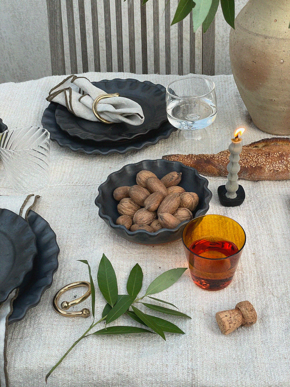 Black iron Japanese candle stand on table with candle.