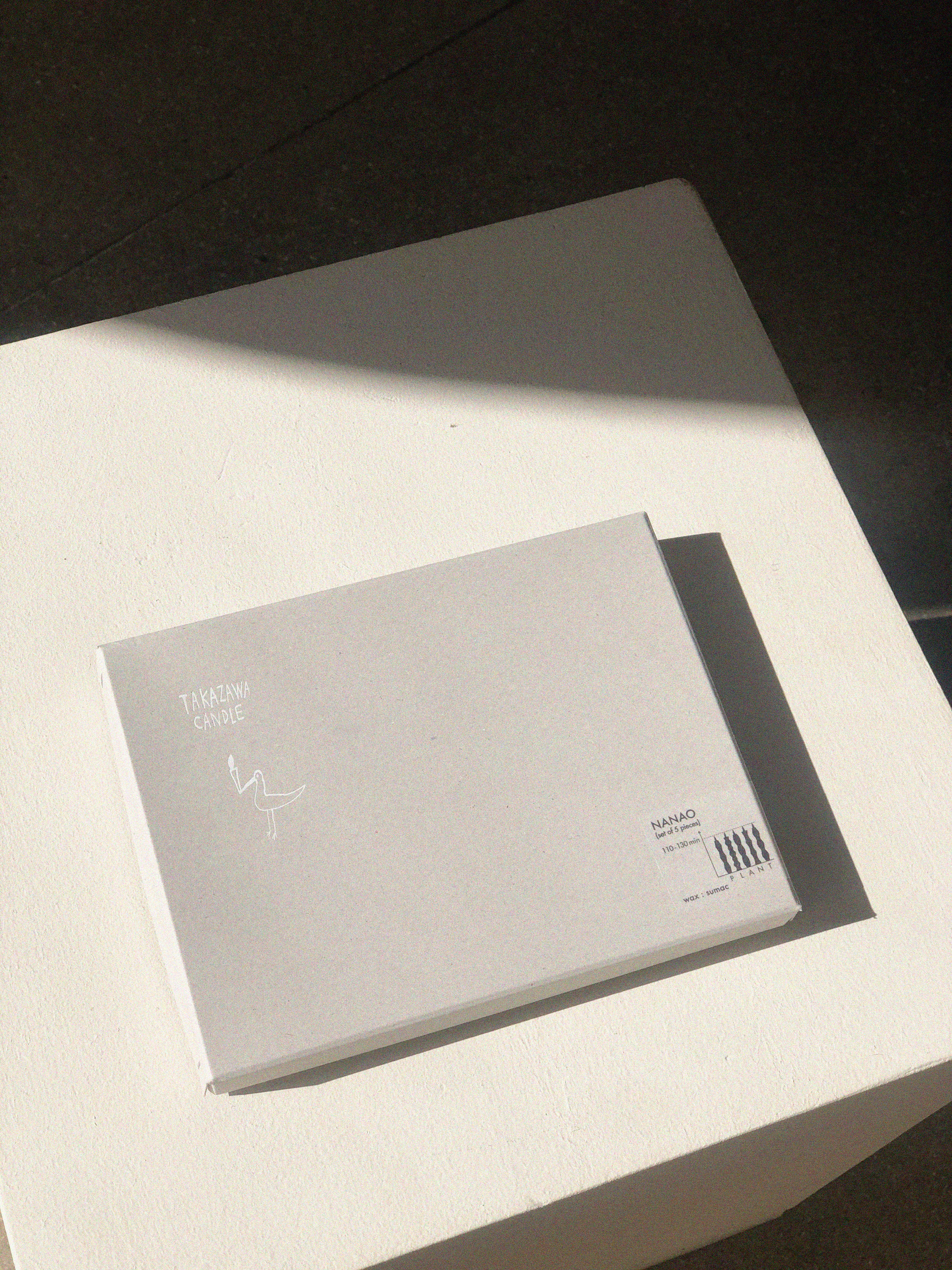 Set of five off-white candles, each one with a different wavy silhouette.